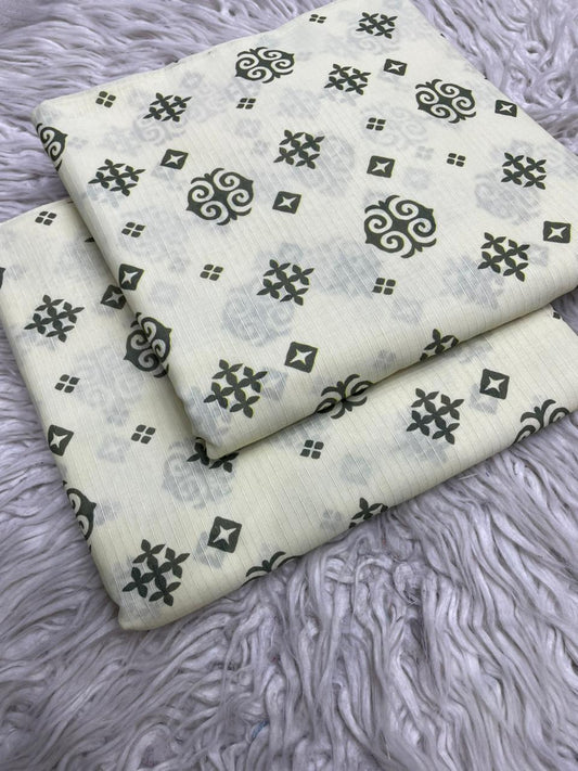 Two pieces of fabric with black geometric patterns on a gray textured surface