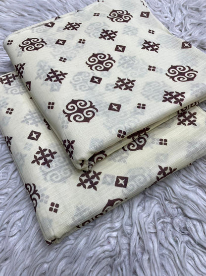 Two pieces of fabric with a brown geometric pattern on a textured gray surface